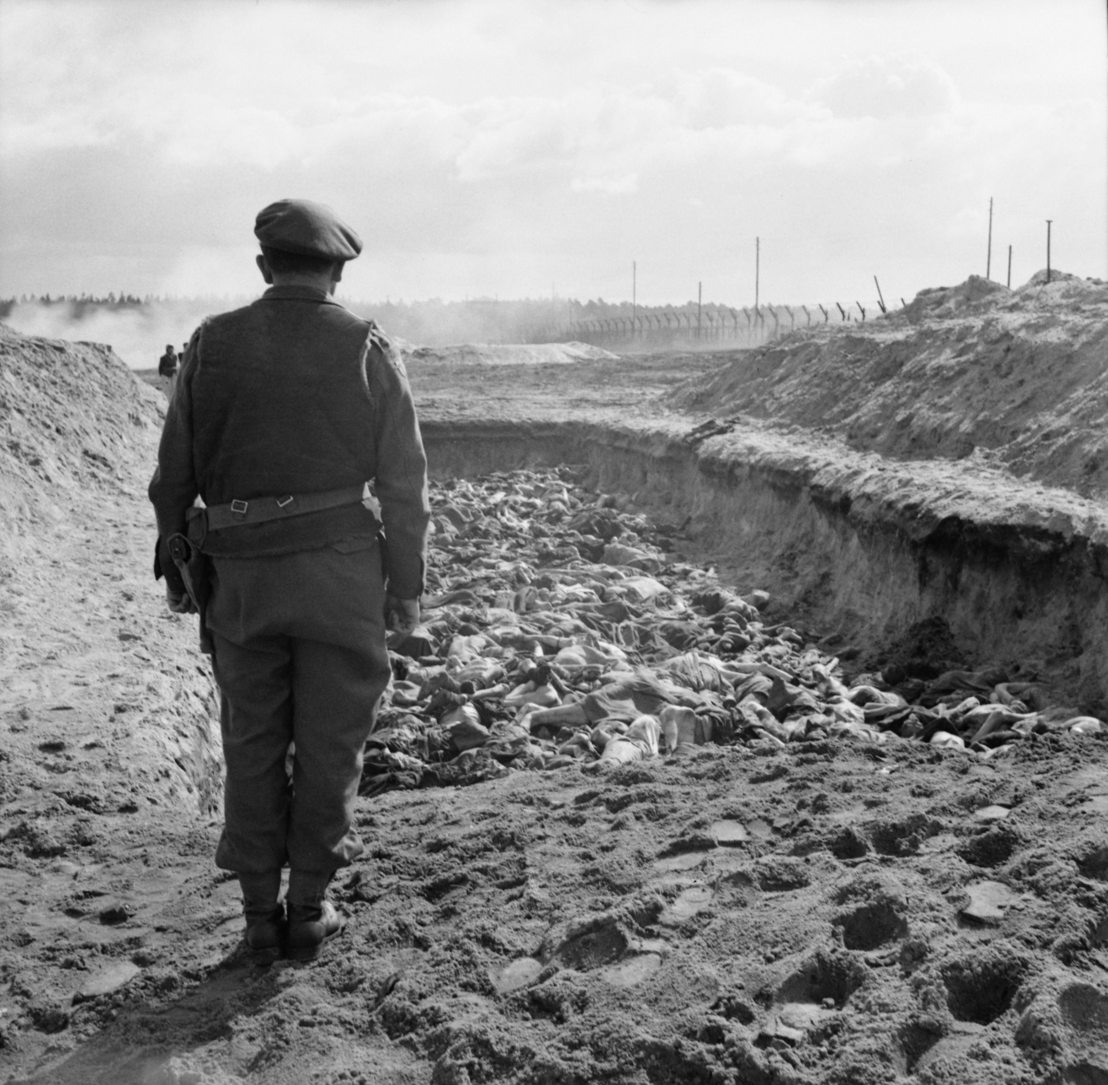 British Army Rabbi Leslie Hardman in front of an open mass grave, 23 April 1945. Photo by Sgt. Oakes. Imperial War Museum, London, Photograph Archive, BU 4269.